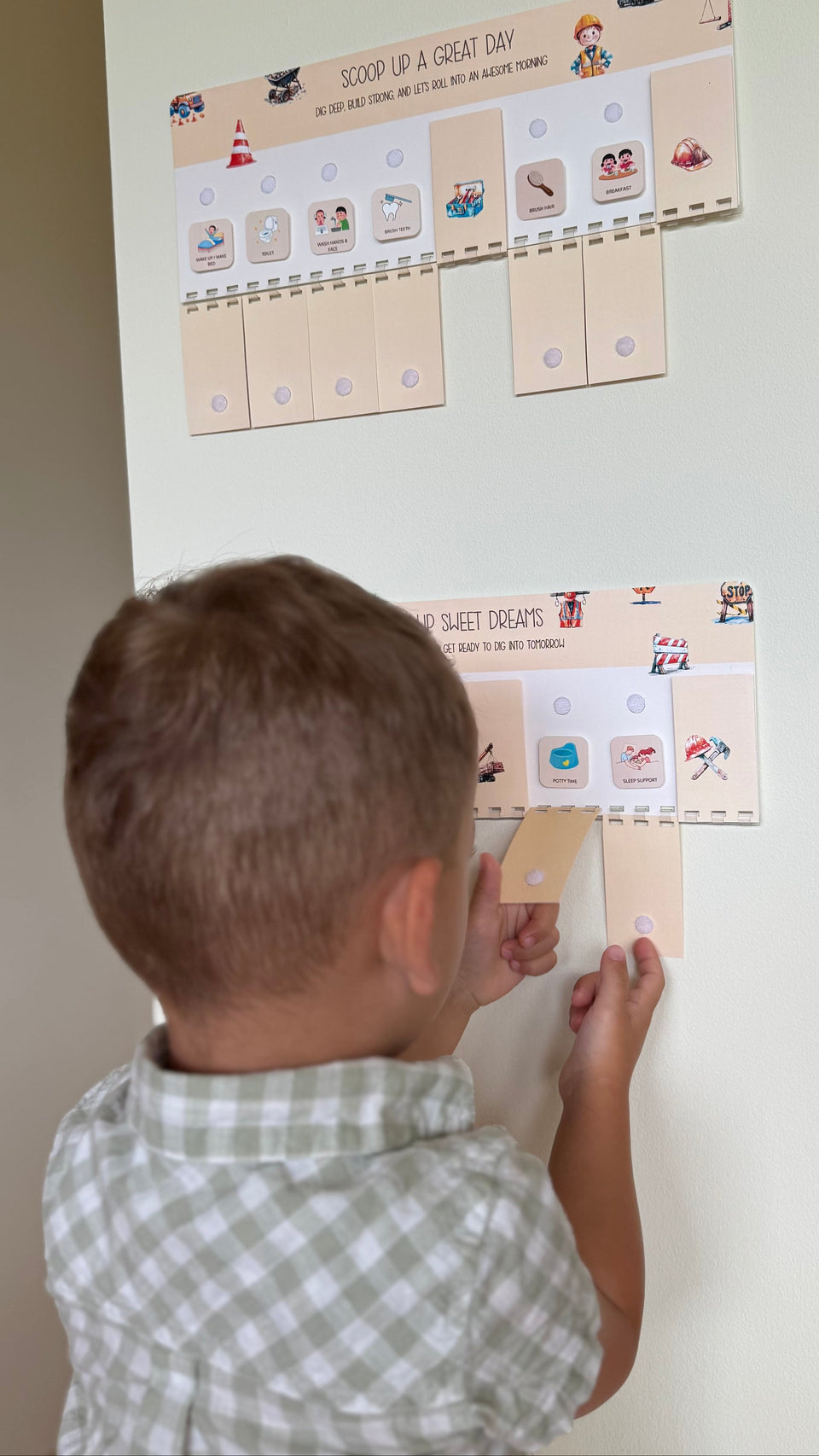  Child interacting with a reward chart on a wall